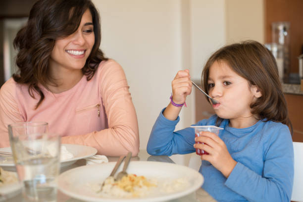 istock Mom and daughter having lunch 1266325418
