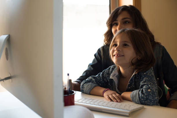 istock Mom and daughter at the computer 1266325452