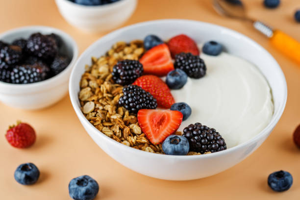 istock Fresh breakfast with greek yogurt nuts oatmeal granola with berries in a bowl 1266327770