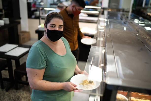 istock Portrait of a customer in a self service restaurant using face mask 1266333556