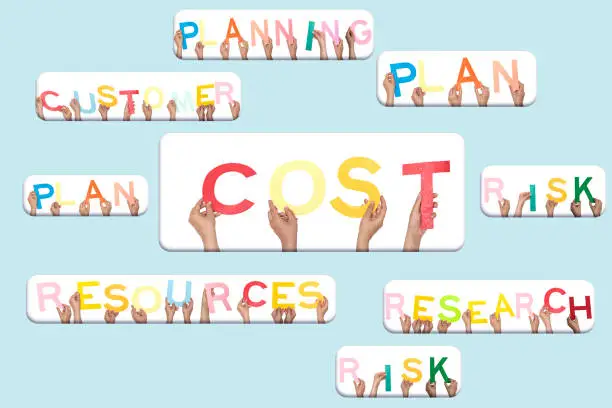 Photo of forming word cost concept with people holding alphabets