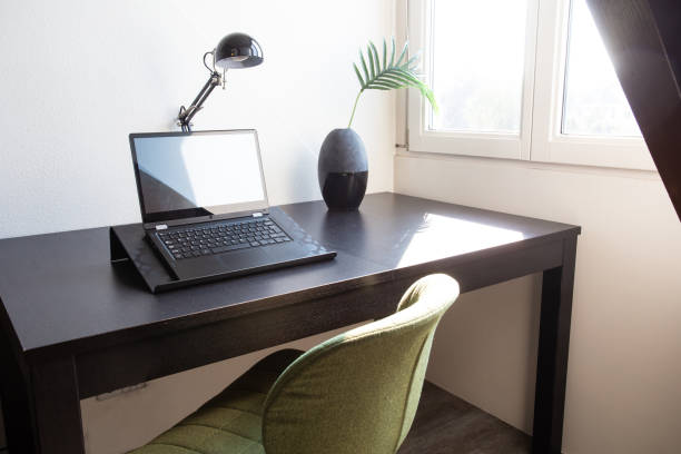 istock Workplace with laptop on table at home near window, modern interior home office desk on a sunny day stylish decoration 1266335408