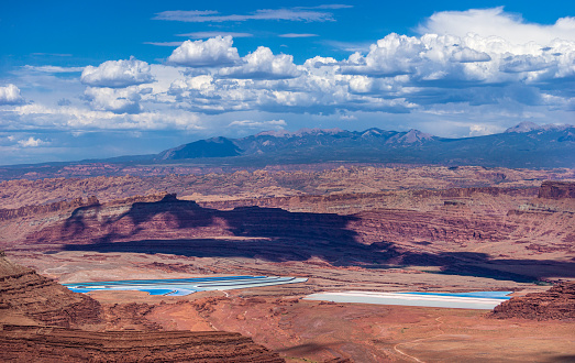 View of potash evaporation pools from Dead Horse Point with La Sal Mountains on the horizon.