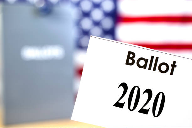 istock Vote 2020 signs with American Flag background 1266335765
