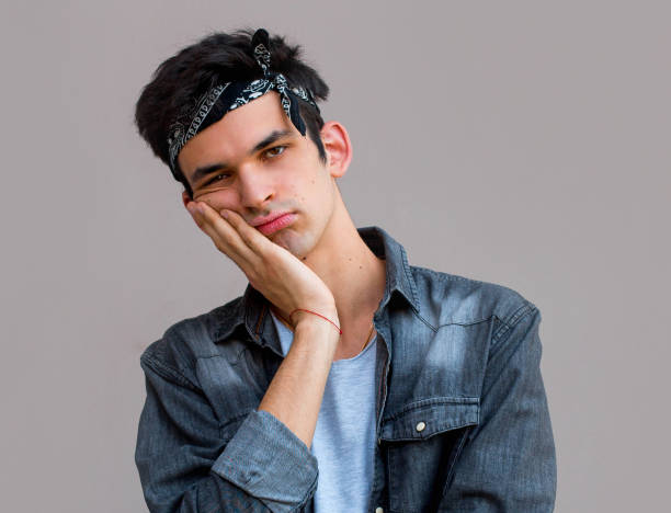 istock Bored european handsome man over gray background 1266336603