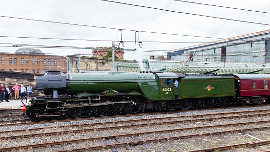 Carlisle, England - August 14, 2016:  The Flying Scotsman, a preserved steam locomotive, is pictured in Carlisle station.  The Scotsman was the first locomotive in the UK to reach 100mph.