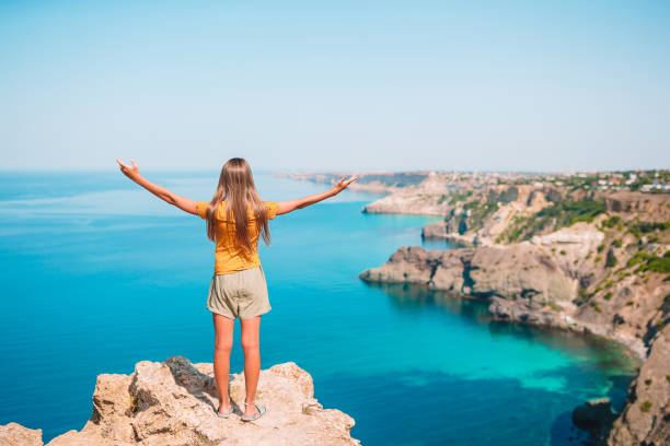 istock Kid on vacation on white rock background 1266341752