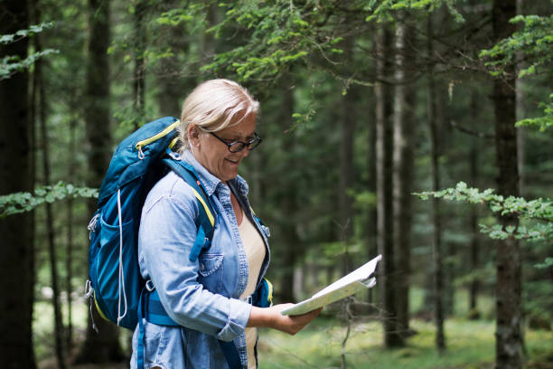 istock Senior women hiking in forest with map 1266342548