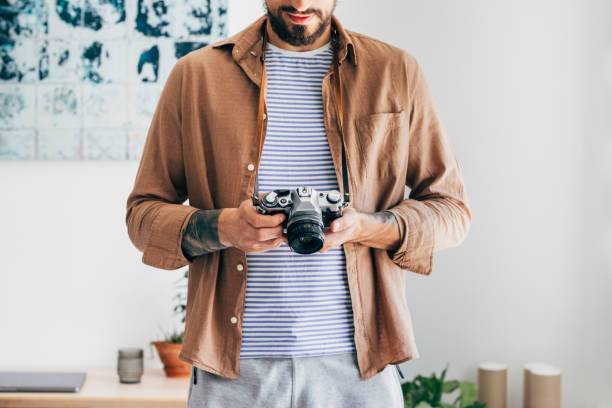 Unrecognizable photographer playing around with his film camera.