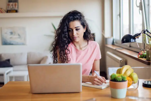 Unemployed young woman searching for a job online.