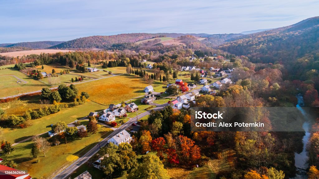 Aerial view of the small town surrounded by the forest in the mountain in autumn morning. Aerial drone view on the small town Kunkletown, Poconos, Pennsylvania, in the fall. Pennsylvania Stock Photo
