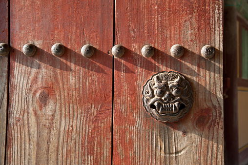 Haetae door knocker at Bulguksa Temple in Gyeongju, South Korea. Haetae is a mythical East Asian creature with the head of a dragon that is supposed to bring good health and prosperity and is often found close to or on the front doors of homes in China and other parts of Asia. It is known as a Chi Lin door knocker in China.
