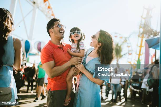 Family Has Fun At Outdoor Carnival Setting Stock Photo - Download Image Now - Family, Amusement Park, Fun