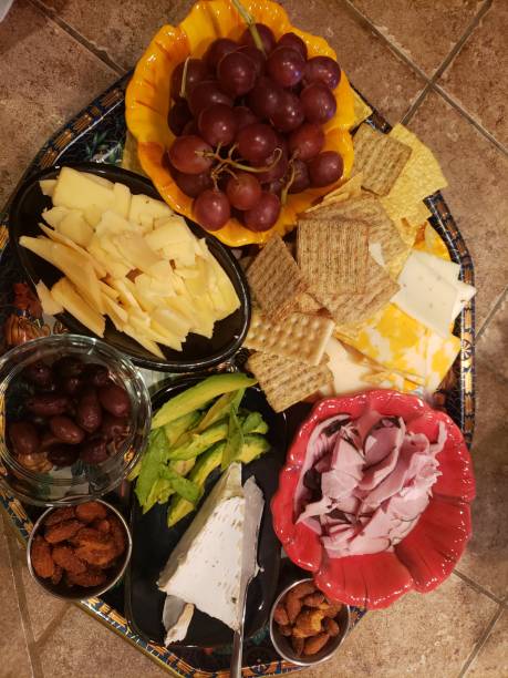 istock Charcuterie tray of cheeses, crackers, fruit and nuts 1266369773