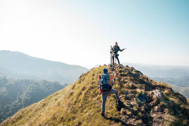 istock Young couple taking pictures while out hiking 1266372039