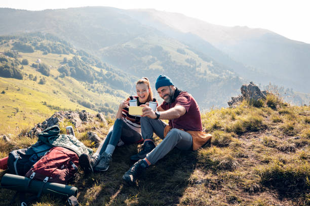 istock Young couple taking a selfie while out camping 1266372141