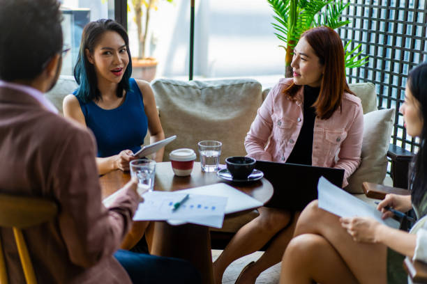 istock Asians Millennials discussing work in coworking space. 1266376836