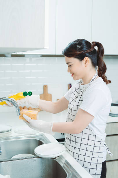 istock Asian lady wash a dish in kitchen room 1266383940