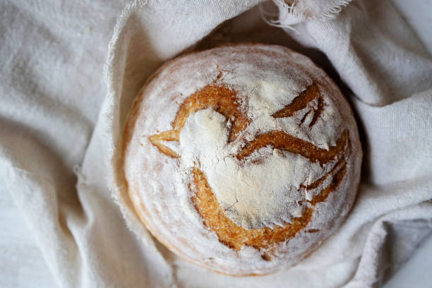 homemade artisan country boule, with a bird pattern slashing
