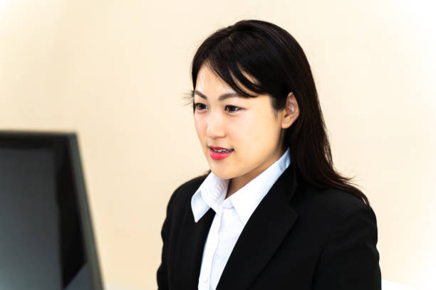 istock Female employee doing desk work in front of a personal computer 1266386572