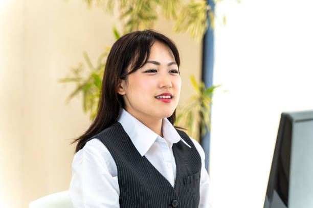 istock Female employee doing desk work in front of a personal computer 1266386642