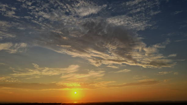 istock Dramatic soft sunrise, beautiful pink violet orange clouds against blue sky 1266387898