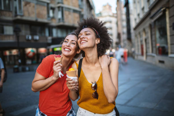 Female friends having fun and eating ice cream