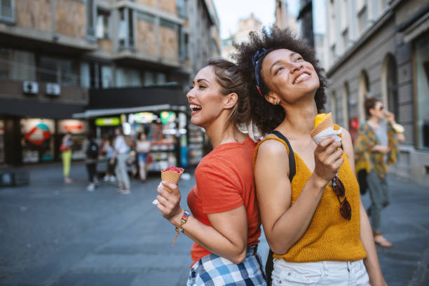 istock Female friends having fun and eating ice cream 1266389974