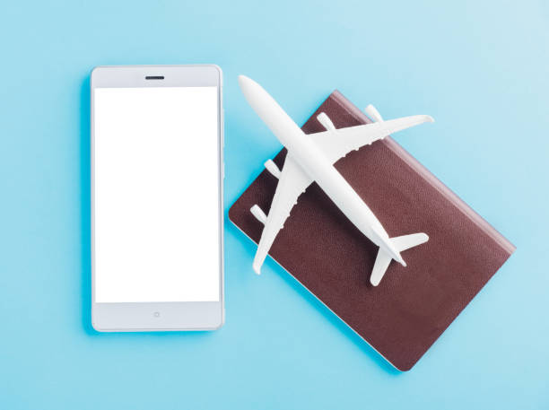 istock model plane, airplane on passport and mobile smartphone blank screen 1266391539