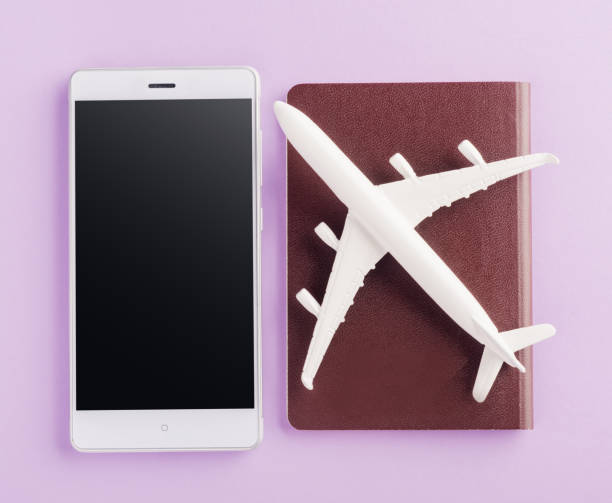 istock model plane, airplane on passport and mobile smartphone blank screen 1266391541