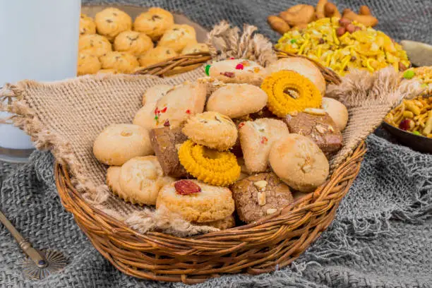 Photo of Group of Sweet And Tasty Mixed Cookies or Biscuits with Namkeen Served in Basket