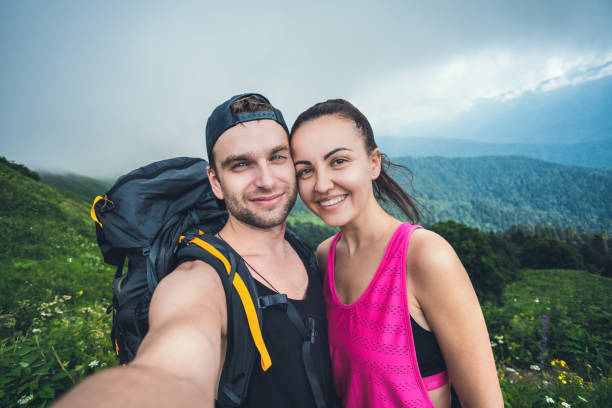 istock Happy couple taking selfie in the mountains 1266396502