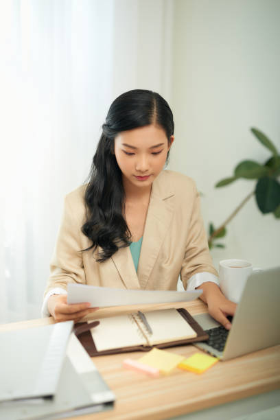 istock Attractive businesswoman studying online, using laptop software, web surfing information or shopping in internet store. 1266397981