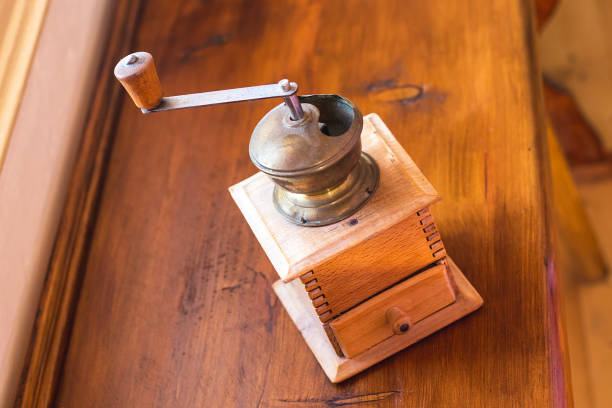 Coffee still life with beans and grinder on white wooden table