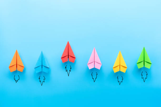 istock Colorful Paper plane on blue background, Business competition concept. 1266408421