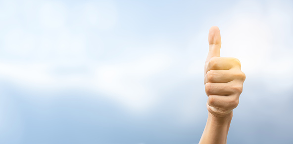 The hand of a businessman shows an excellent mark with a thumb up. Excellent work, congratulates and businessman success concept.