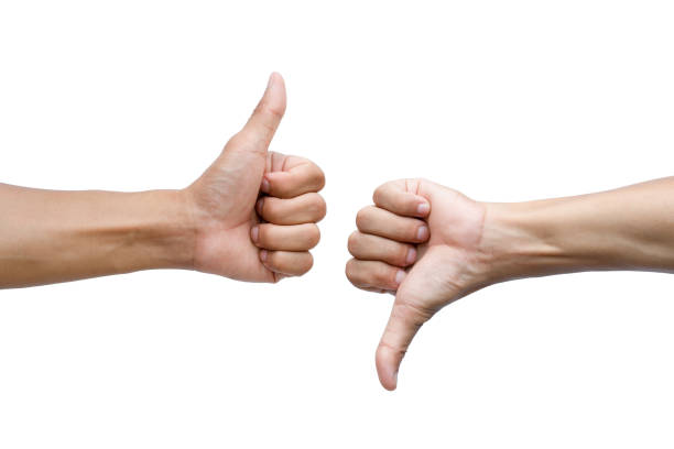 Thumbs up and thumbs down on white background stock photo