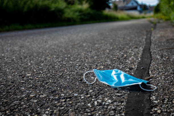 istock Covid face mask laying on the street 1266409828