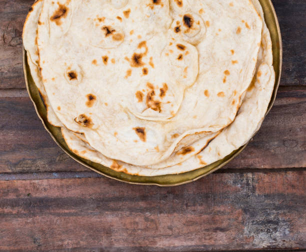 Indian Cuisine Tandoori Roti Served in Basket on Wooden Background Indian Cuisine Tandoori Roti Served in Basket Also Called Chapati, Flatbread, Naan or Nan Bread on Wooden Background taftan stock pictures, royalty-free photos & images