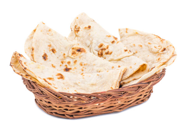 Indian Cuisine Tandoori Roti on White Background Indian Cuisine Tandoori Roti Served in Basket Also Called Chapati, Flatbread, Naan or Nan Bread on White Background taftan stock pictures, royalty-free photos & images