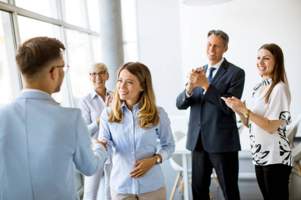 istock Young business partners making handshake in an office 1266414064