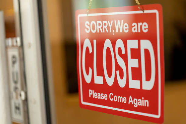 istock Store closed sign hanging on the window 1266414518