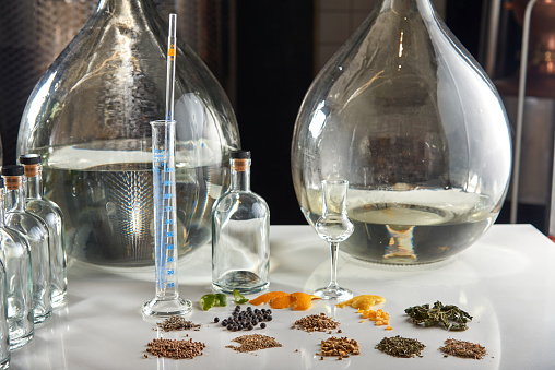 Gin ingredients on table in craft distillery.