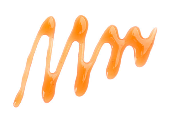 istock Maple syrup drizzle isolated on white background. Splashes of sweet maple syrup. Top view. 1266415523