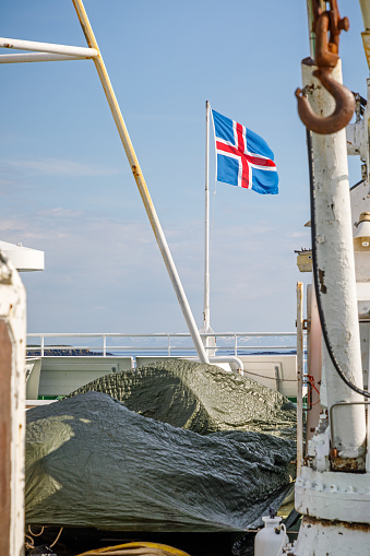 Westfjords, Northwestern Iceland, June 28, 2020: Icelandic flag in the back of a ferry close to Flatey