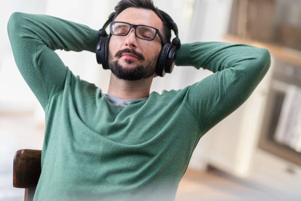 istock Young Man Listening To Music 1266417792