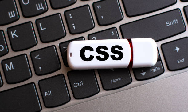 CSS - the word on a white flash drive, lying on a black laptop keyboard CSS - the word on a white flash drive, lying on a black laptop keyboard. Technology concept cascading style sheets photos stock pictures, royalty-free photos & images