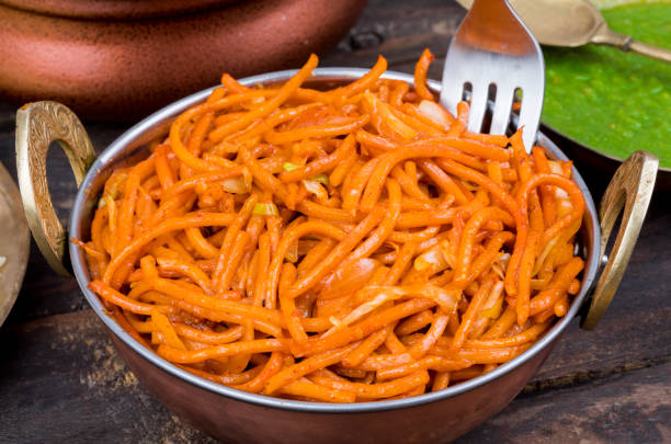 istock Spicy Fried Vegetable Veg Chow Mein on Wooden Table 1266419073