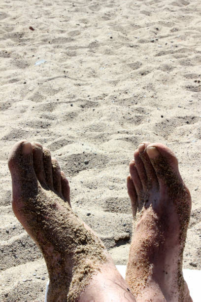 istock male feet on the beach 1266420055