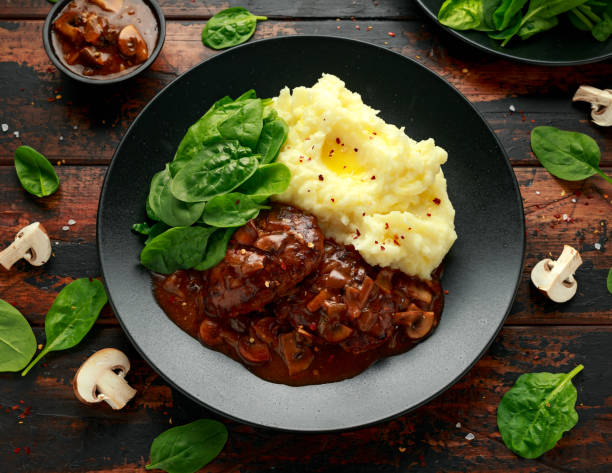 istock Salisbury Steak with mushroom gravy, mashed potatoes and spinach 1266421482